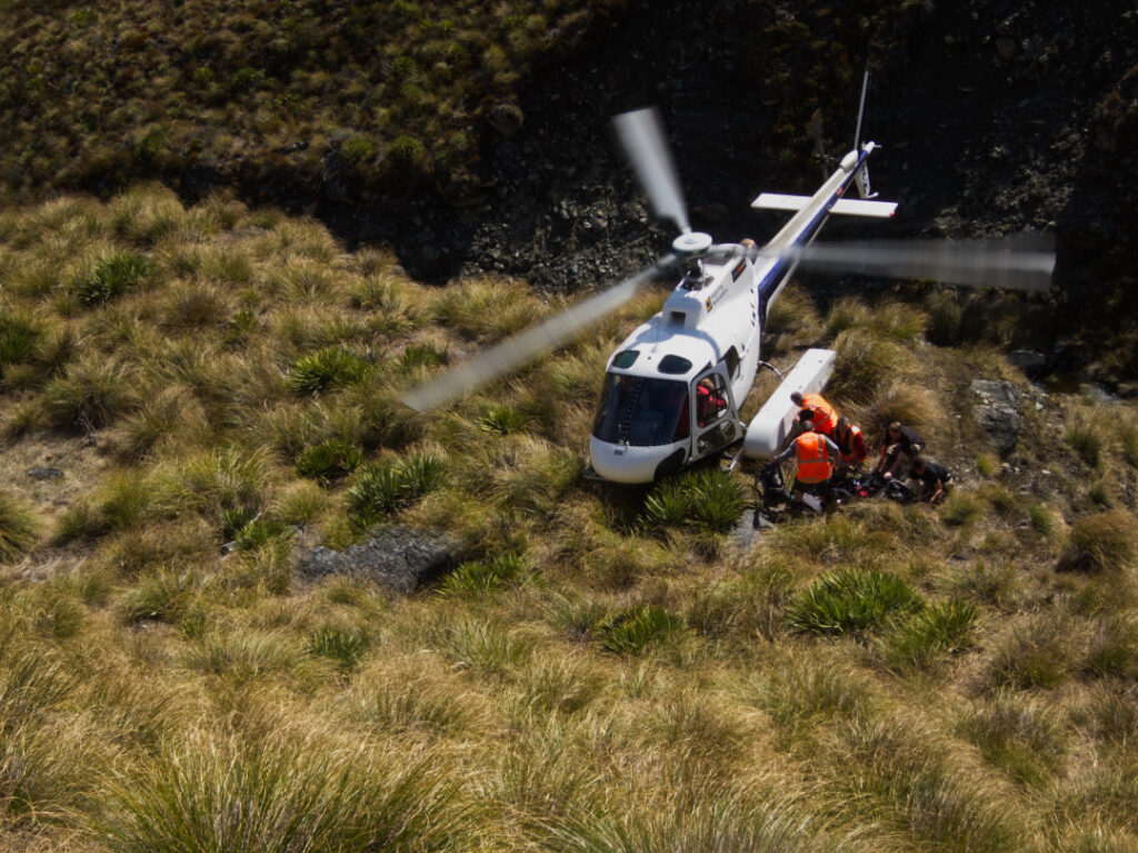 Squirrel helicopter picking up trampers, Otago, New Zealand